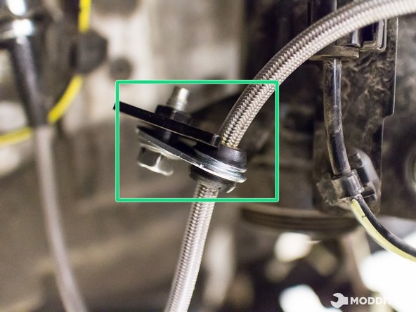 You may now tighten remaining bolts securing the stainless steel braided brake line to the vehicle.