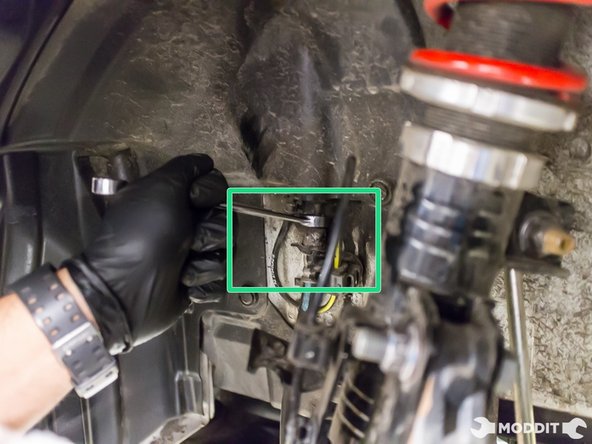 Using a 10 mm line wrench, separate stainless steel brake line from rubber brake line.