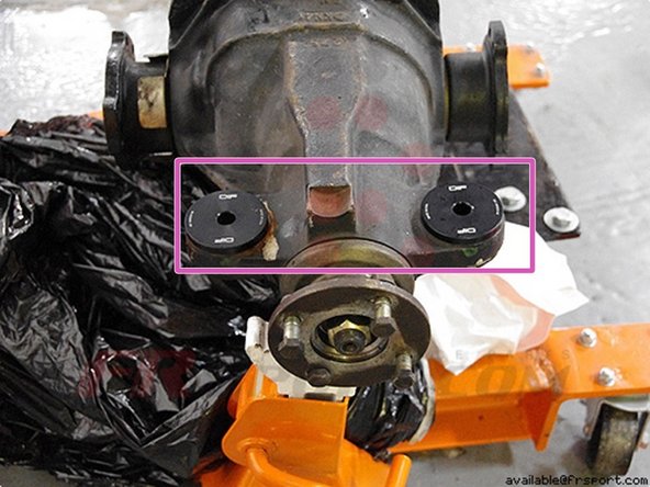 After the stock bushing is removed, you can slip on the DIF solid differential bushing pieces. The washer side goes on top, while the other piece slips in through the bottom.