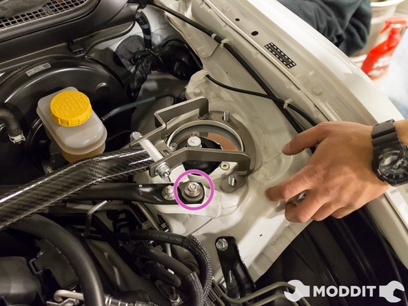 After placing the strut bar at the correct position, carefully and loosely finger thread the nuts on the stud. Make sure that they do not cross thread, or you will have a bad time.