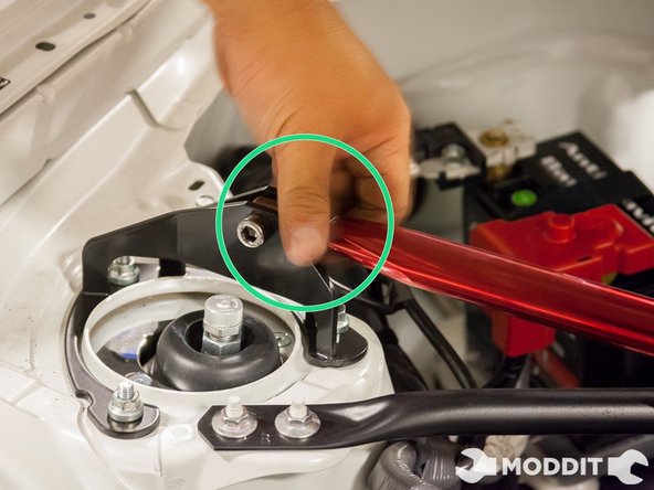 Rotate the center portion or body of the strut bar so that it becomes flat or parallel to the ground and you can clearly see the Tanabe logo facing the top.