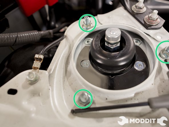 Using the same method from the rear coil, go ahead and hang the strut from the strut tower. By barely threading the nut on the stud, you have a lot of play to move the coilover around.