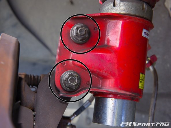 Remove the two bolts from the strut to the spindle.