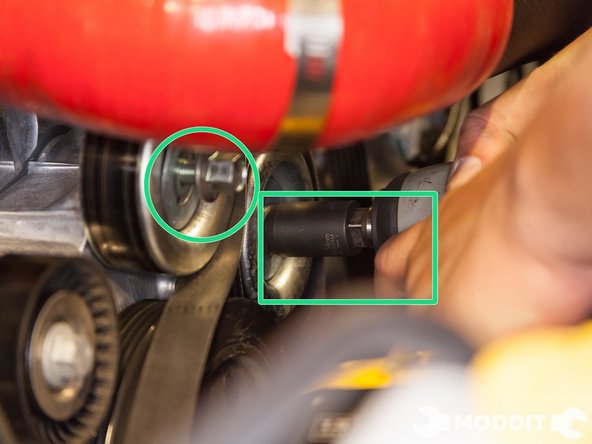 With the 14mm socket, loosen the bolts to both idler pulleys.