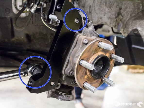 With a 17 mm socket, torque aluminum caliper bracket to factory spec.