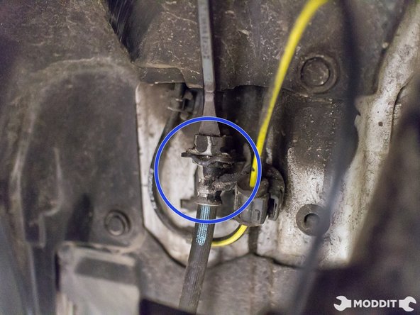 Remove locking clip, securing rubber brake line to stainless steel brake line against the chassis