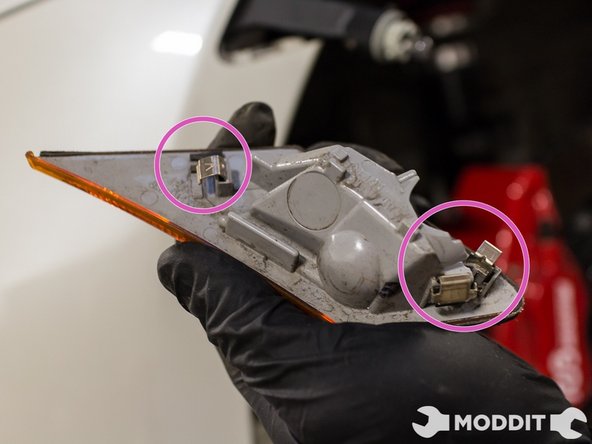 Note: Be sure to push in the bulb holder through the bumper so when removing the bumper, it won't be caught and rip. Do this on both sides.