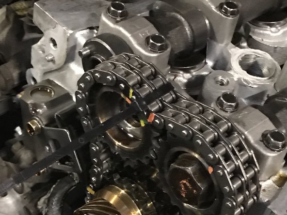 Initially install the gears to the cam and tighten by hand. You will have to rotate the cam slightly with a wrench to line up the dowel pin. Once aligned and fitted, check to see that the sprocket is fully seated against the cam before torquing the bolt to spec.