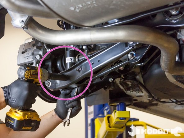 We started first with the rear section of the car. We removed the 17 mm nut holding the strut to the lower control arm.