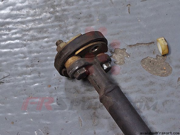 After you remove the nuts, the part of the column containing the bushing should just slide out.