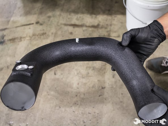 With the radiator support loose, lift the driver side and snake the Perrin intake pipe into place.