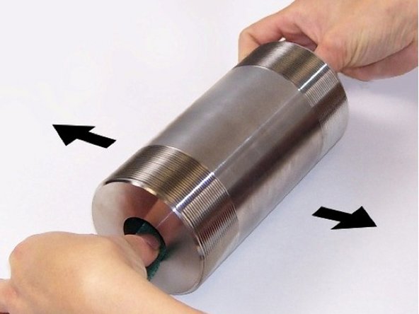 To refinish cylinder bore, place cylinder on a table. With a piece of 180 grit abrasive paper in each end, roll cylinder back and forth to remove blemishes.