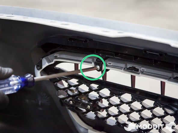 Use the correct sized phillips screw driver and start removing the screws that hold that grille into the bumper.