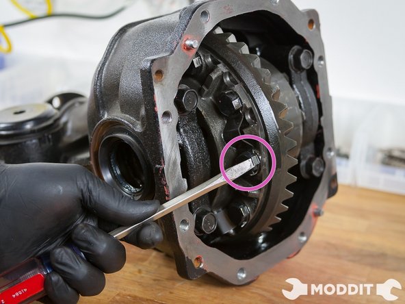 Begin by hammering down, with the aid of a srewdriver, the locking tabs that secure the bolts fastening the LSD Ring