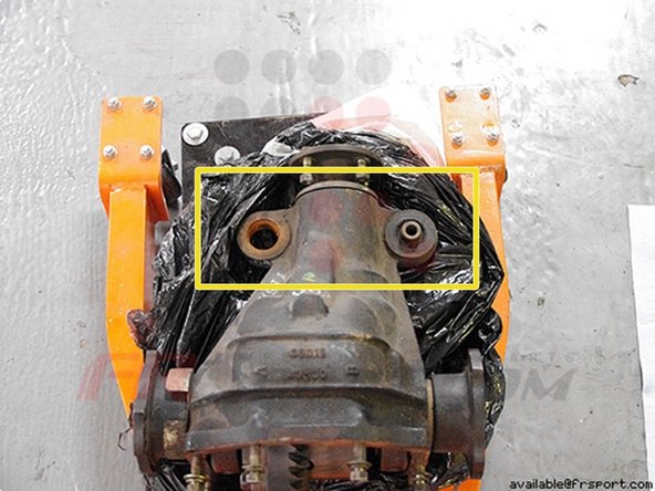 To the left you can see the stock bushing is removed from the left hole and still attached on the right hole.