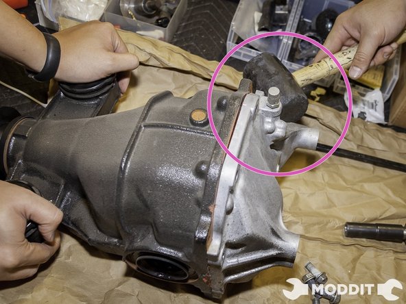 Once they are all out get a small hammer gently dislodge the rear cover until it is completely off. A good spot to tap it from would be the Right Bushing Bolt receiver section. This allowed us to easily pop the cover off.