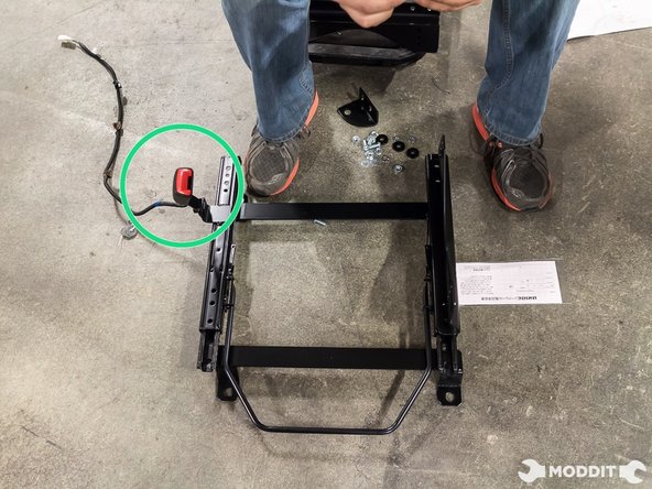 The first think you want to do is bolt on the seat belt buckle receiver into the new seat rail.