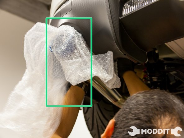 Begin the installation of the exhaust at the most rear part of the exhaust. Hang the Tomei megaphone tip of the exhaust  first using slight lubrication on the exhaust hanger.