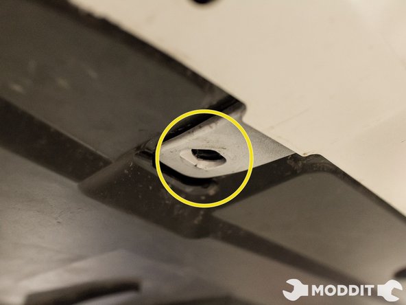 On the underside as well, remove the two bolts with a 10 mm socket. Surprisingly, these are actually the only two metal bolts on the underside.