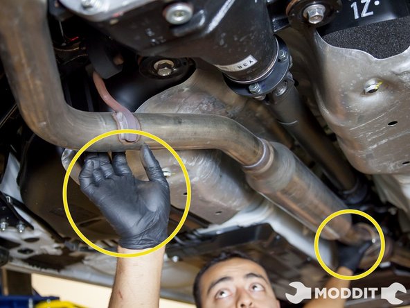 White supporting the front, remove exhaust center pipe from exhaust bushings