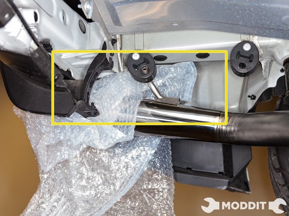 After hanging the axleback, its time to Install the T-Clamp with the threaded portion on top. Make sure the nut is facing the driver side of the car.