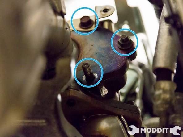 Remove 5 bolts/nuts holding the downpipe to the turbo