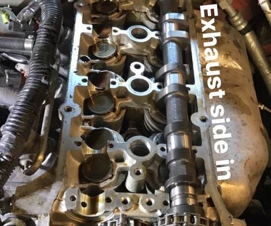 11)    Installing the cam. Inspect cams to be clean and clear of all debris and burs. One will be labeled “IN” and the other will be labeled “EX” so be sure to note which is which. Lubricate the cam carriages where the cams sits with assembly lube. We used Torco MPZ Engine Assembly Lube. A 0.5oz will be more than enough.