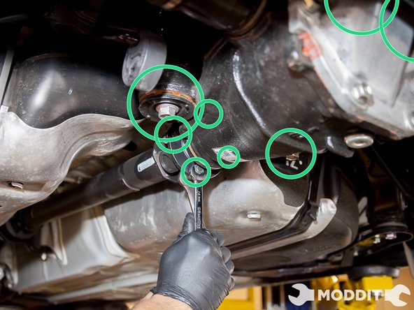 As you raise the differential pumpkin bolt the back of the differential cover and the two front differential ears to the rear sub-frame at the corresponding spots. Finally bolt the drive shaft to the pinion gear at the front of the pumpkin.