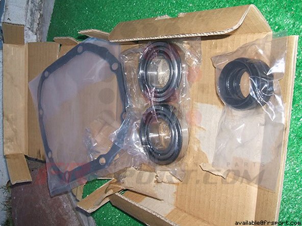 Step 9 Tomei Differentials come with the axle shaft seals so remove the old seals by hammering them out with a flathead.