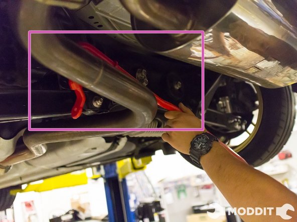 Our first step of the Tanabe sway bar install is to maneuver the bar around the exhaust and attach the end links.