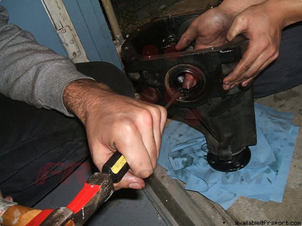 Step 9 Tomei Differentials come with the axle shaft seals so remove the old seals by hammering them out with a flathead.