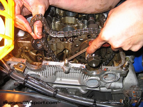 Figure 2- Guiding the chain back on- Make sure the timing chain is sitting on the chain guide. Re-install the sprocket on the cam.