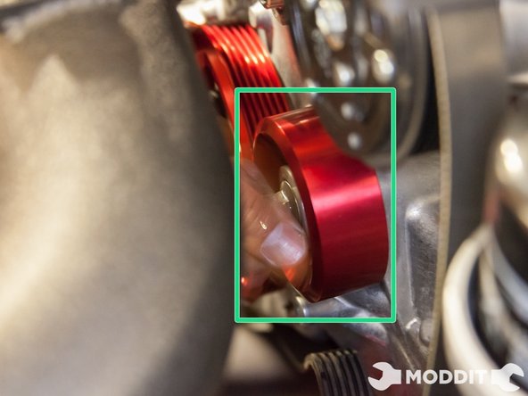 Then line up the holes and put the bolt through them. There are two idler pulleys that need to be installed, Repeat the process for the 2nd one.