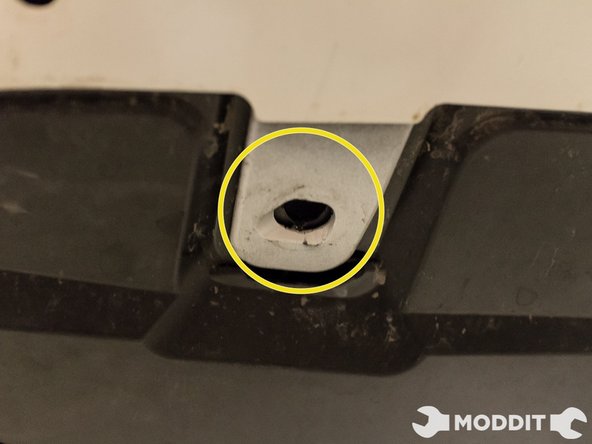 On the underside as well, remove the two bolts with a 10 mm socket. Surprisingly, these are actually the only two metal bolts on the underside.