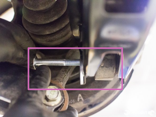 Insert bolt through the arm in the direction of the rear.