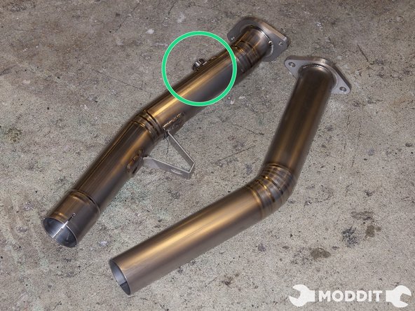 Tomei front pipe has an additional bung near the catback that will be ultilized when installing headers or for tuning.