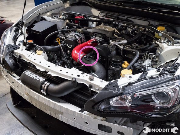 With the intake pipe reclocked, you can now secure the remaining clamps on the tubes and the bolt on the pipe to the radiator support.