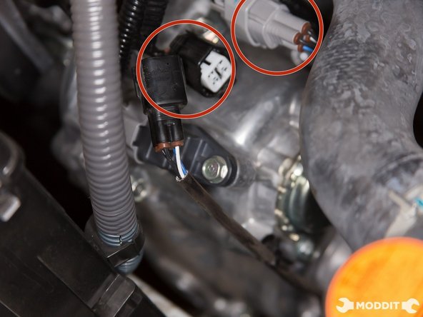 You now have to un-clip the two o2 sensor pig tails. The black and the grey one.