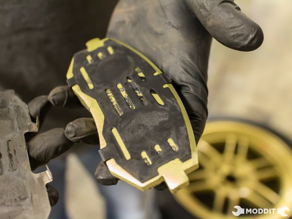 Install Factory Shims on to new pads. Shims will serve as an insulator between the piston and the new pad.