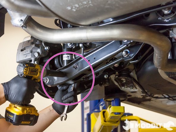 Removal/Installation of the Rear Suspension: We started first with the rear section of the car. We removed the 17 mm nut holding the strut to the lower control arm.