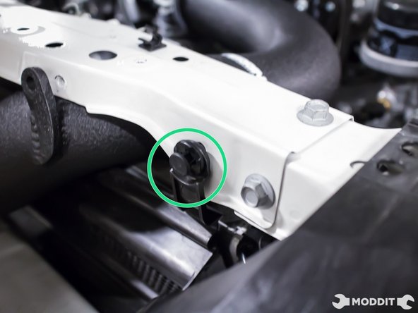 Using the factory plastic clips, reinstall two upper mounting points of the air diverter.