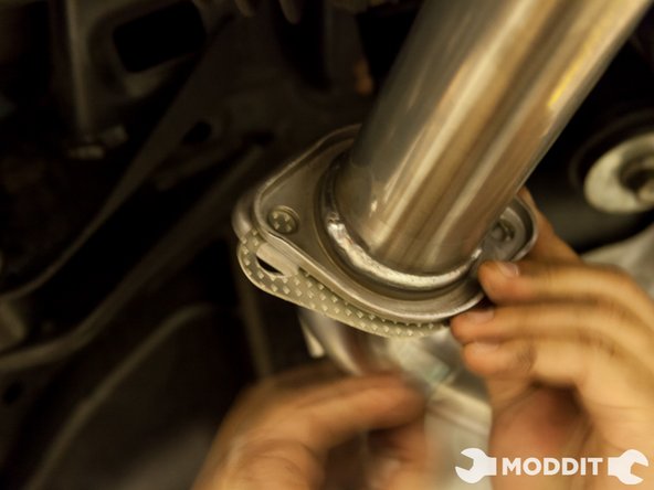 Since the full exhaust loosely mounted go ahead and slip in the provided exhaust gasket.At the same time insert the provided bolts to keep everything together