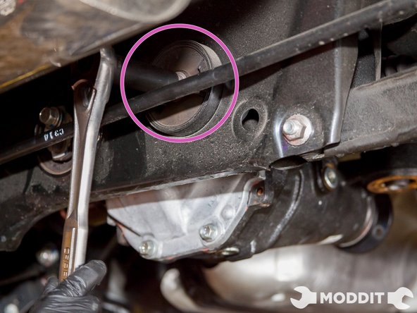 Then proceed to loosen the right bolt holding the rear differential cover bushing. Use a 17mm 1/2 deep socket if you have one. Because many people will have different exhausts use your best judgement on socket selection to maneuver apprpriately