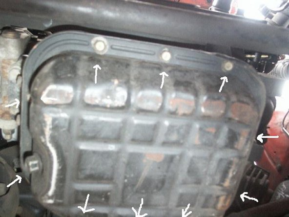Use the 10mm socket and extension to loosen each bolt around the oil pan.
