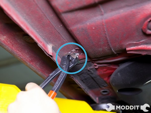 The same technique applies to the Central/Right under tray as the opposite side. Locate all the dampening material clips, remove them, and be sure to use force when removing the clips.