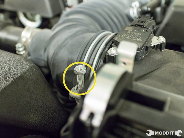 Using a 10mm socket or a philips screw driver, loosen the clamp securing the intake hose to the intake filter box.