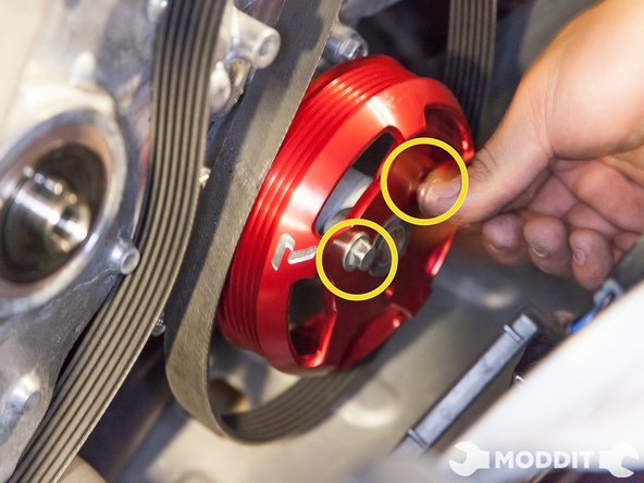 With the water pump pulley on, thread in the bolts, but do not completely tighten them yet.