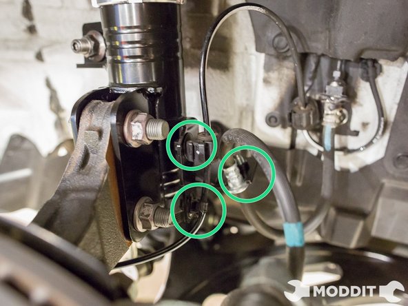 Once the end link is complete, you can now finnish up by clicking in the clip for the ABS line and then bolting down the brake line as well.