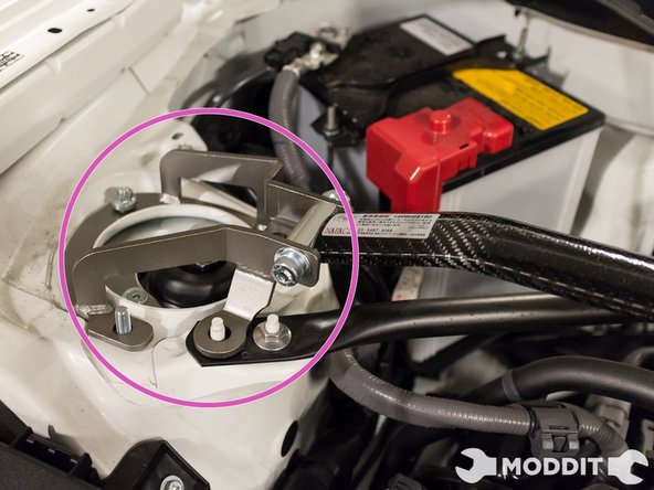 After removing all the necessary nuts, go ahead and place the strut bar on the towers. Aligning the holes on the strut bar with the stud on the towers.