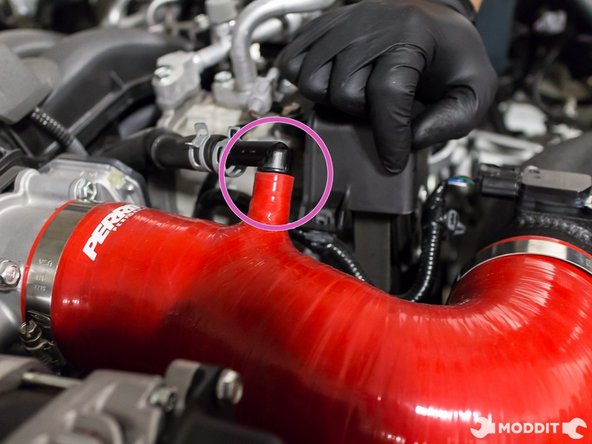 Insert the plastic vacuum port and then secure with factory compression clip.